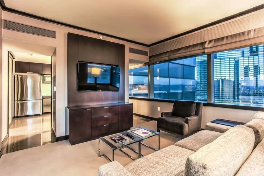 Living room with a sofa, armchair, television and windows